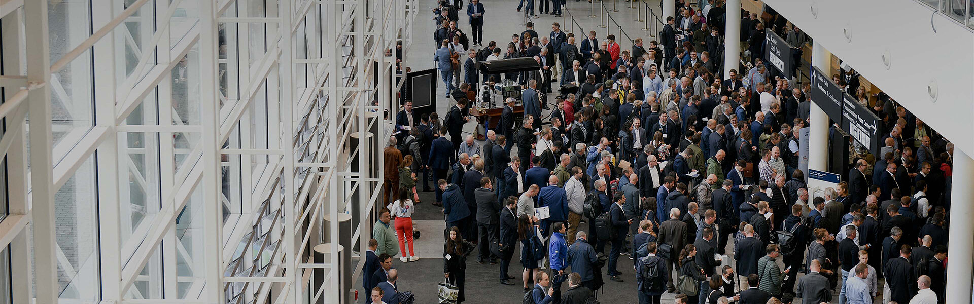 Top view of a big group of fair visitors inside the Hamburg Messe building.