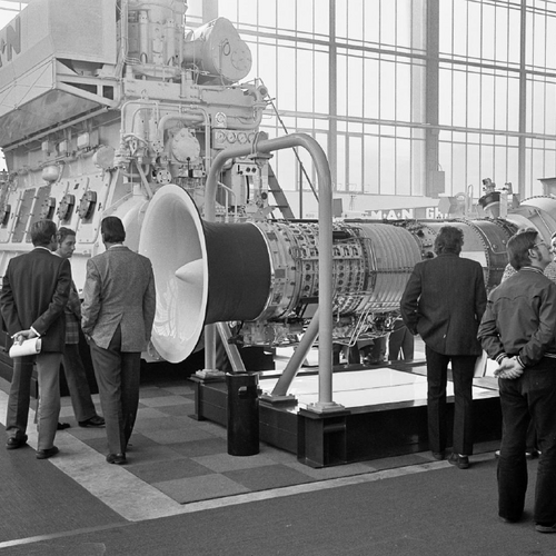 Big ship parts that are exhibited at a fair and viewed by visitors.