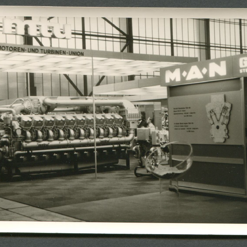 A historical picture of a fair stand of the Motors and Turbine Union, with a bit displayed turbine.